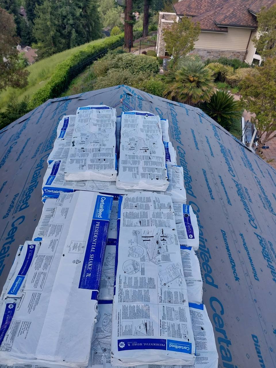 Presidential Shake TL shingle bundles staged on roof deck before installation